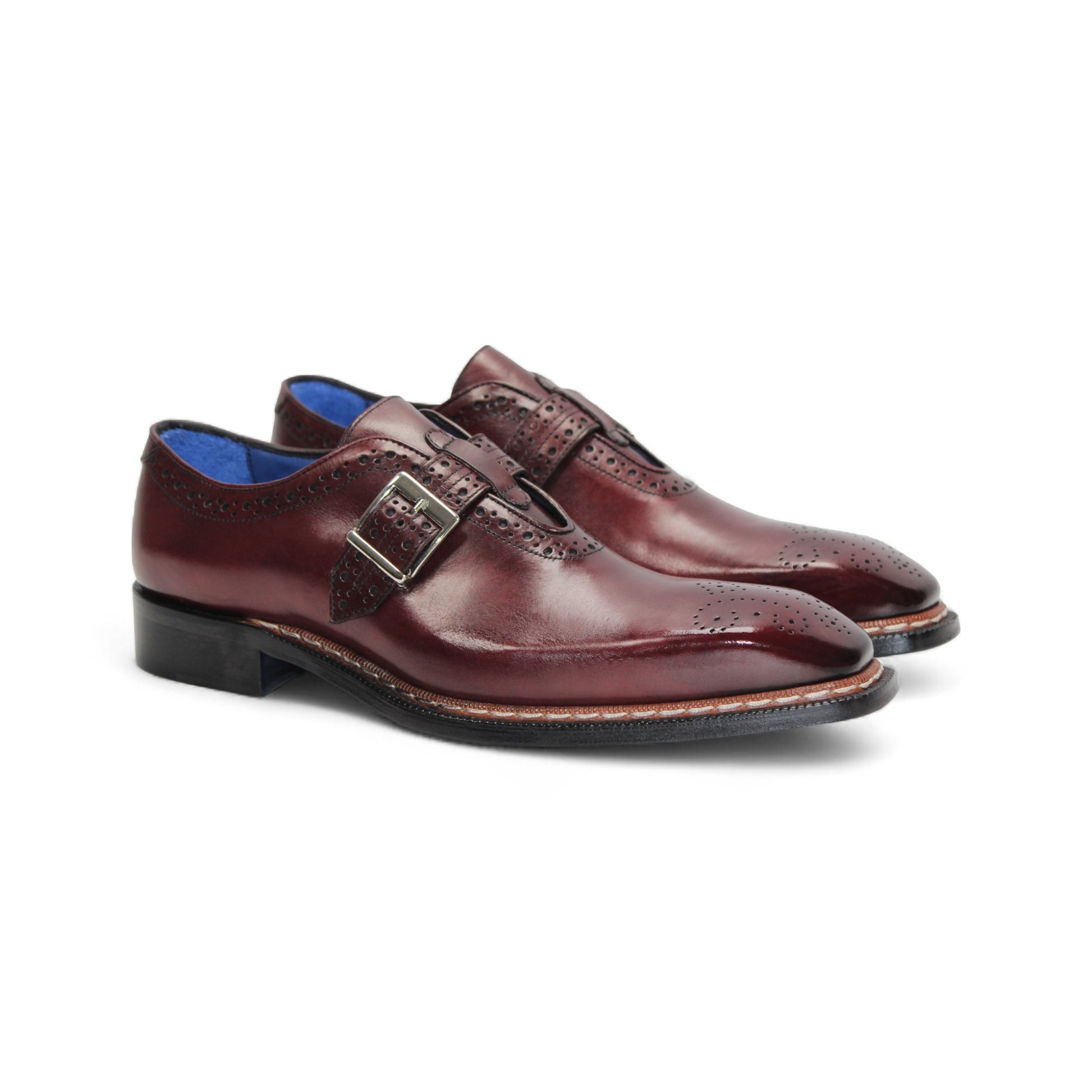 The Emilio Franco Filippo Burgundy is a single burgundy leather dress shoe with a buckle strap, brogue detailing, and a low black heel, crafted from genuine leather to showcase Italian craftsmanship.