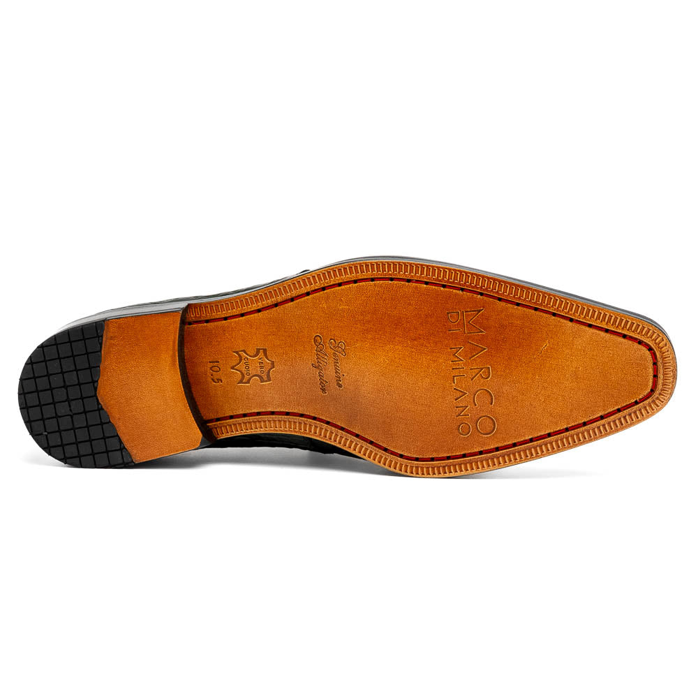 A pair of Fitipaldi Olive luxury footwear by Marco Di Milano in black crocodile leather—one shoe upright, the other showing a tan sole with "Marco Di Milano" embossed—crafted with hand-painted finishes for an elegant touch.