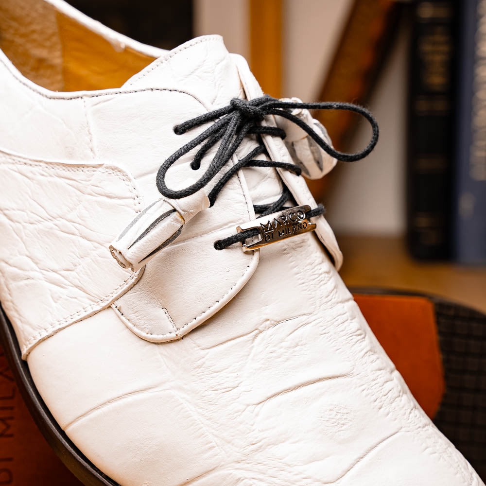 The Fitipaldi White by Marco Di Milano is a luxury men's dress shoe in white leather with black laces and an orange-brown sole, featuring the brand's signature style—ideal for those seeking standout footwear.