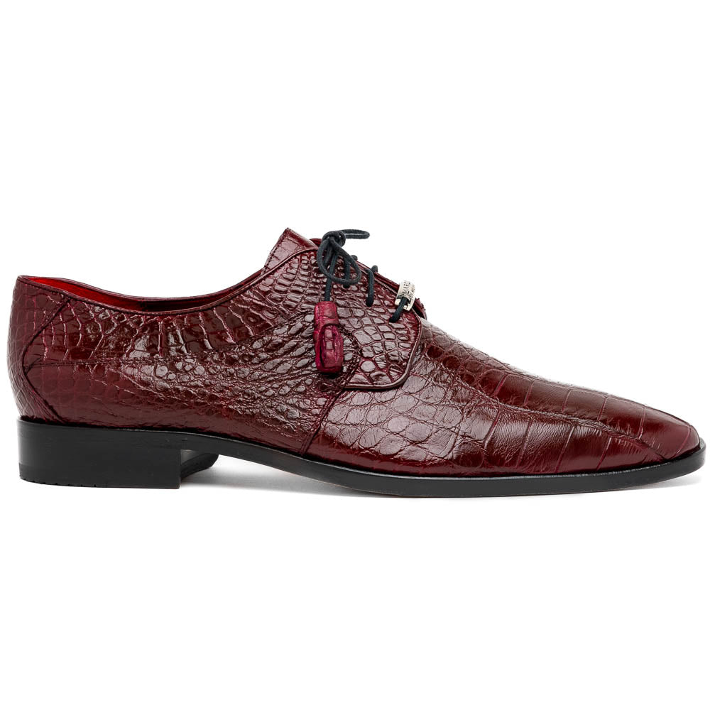 The Fitipaldi Wine by Marco Di Milano is a burgundy crocodile-pattern leather dress shoe with black laces, shown on its side to reveal the tan sole and logo—highlighting hand-painted details and luxury craftsmanship.