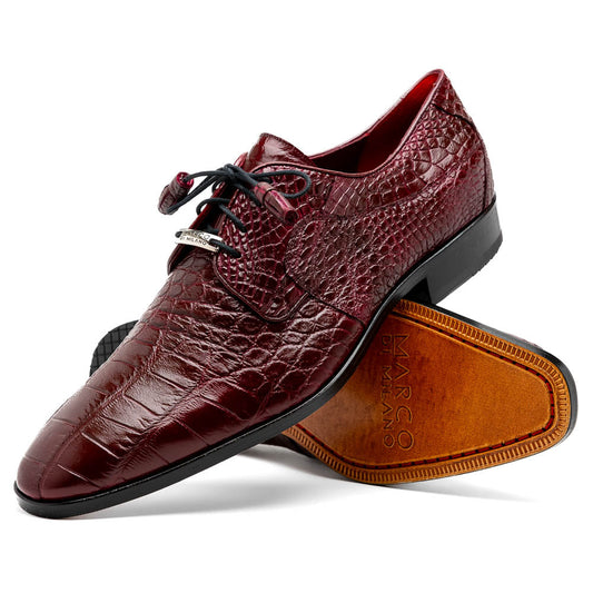 The Fitipaldi Wine by Marco Di Milano is a burgundy crocodile-pattern leather dress shoe with black laces, shown on its side to reveal the tan sole and logo—highlighting hand-painted details and luxury craftsmanship.