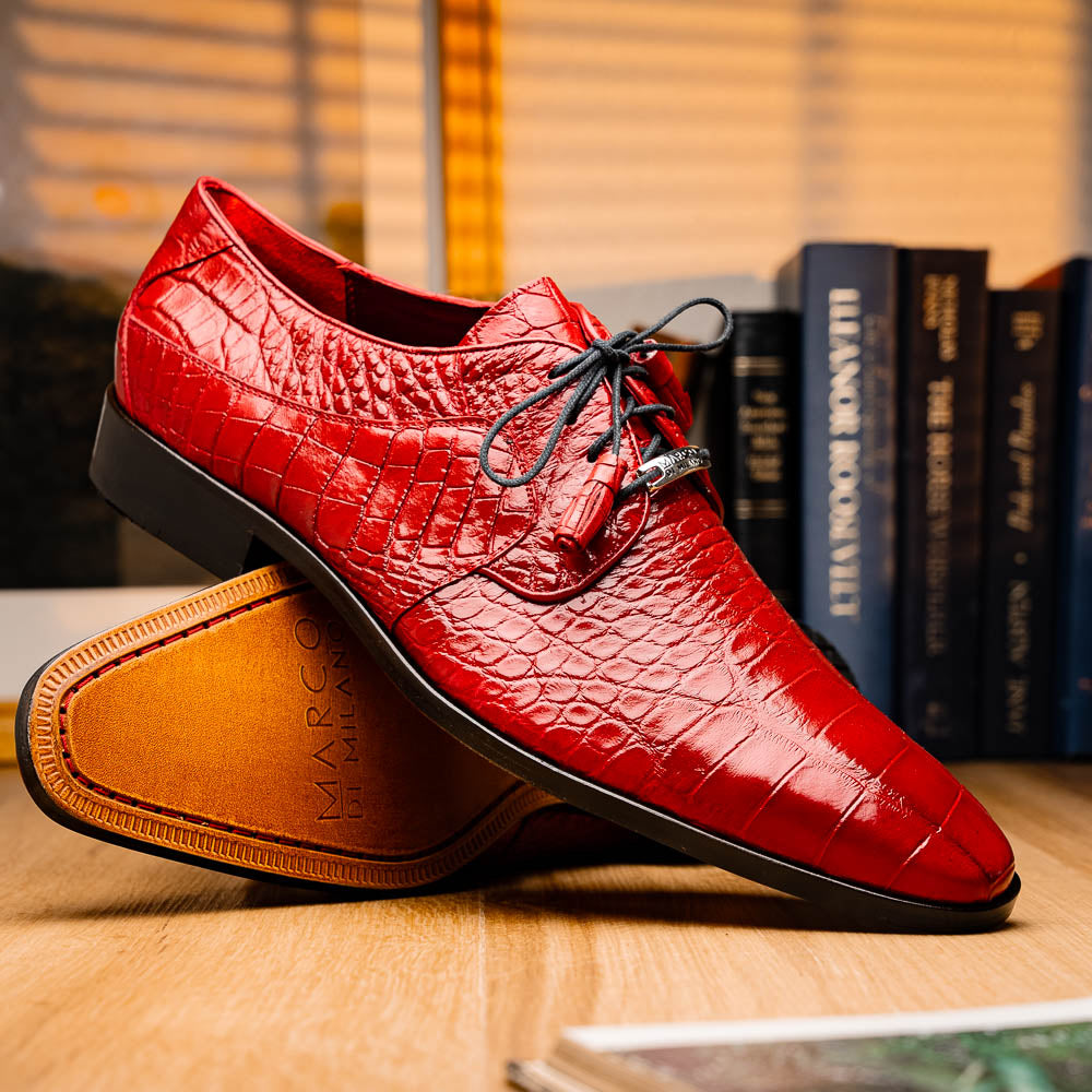 The Marco Di Milano Fitipaldi Red features luxury handmade men's shoes in red crocodile-pattern leather with black laces and brown soles—one shoe upright, the other propped beneath.