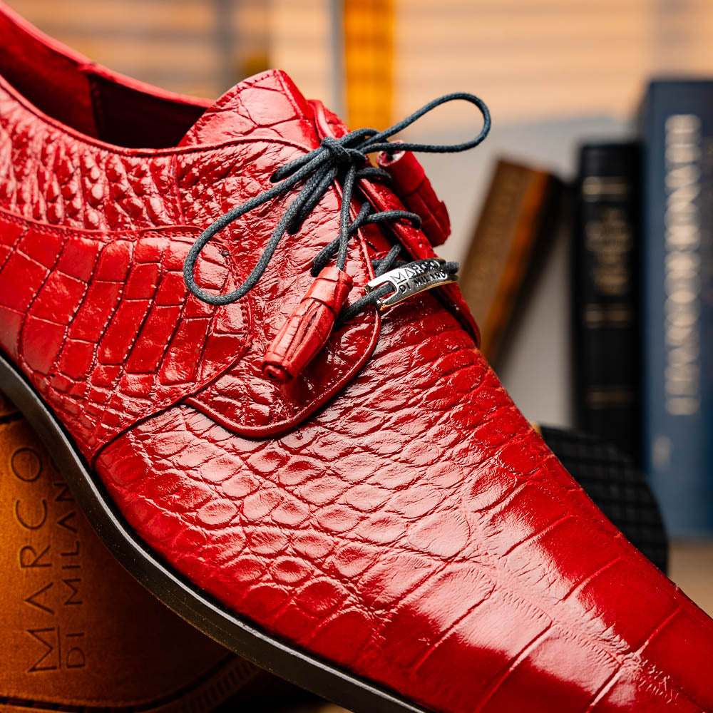 The Marco Di Milano Fitipaldi Red features luxury handmade men's shoes in red crocodile-pattern leather with black laces and brown soles—one shoe upright, the other propped beneath.