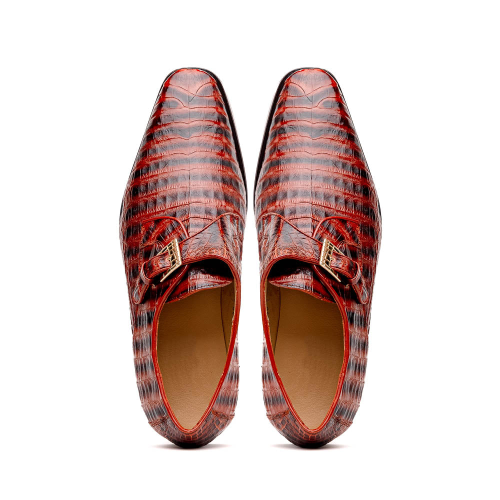 The Rovigo Cognac Straps by Marco Di Milano are brown genuine caiman crocodile monk strap dress shoes with a metal buckle—one upright, one on its side showing the branded sole. Luxury footwear for refined taste.