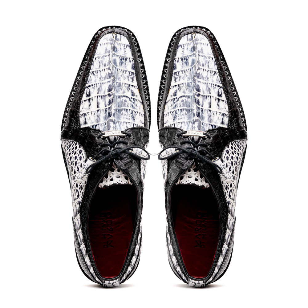 A pair of Marco Di Milano Caribe Newspaper / Black luxury dress shoes crafted from genuine hornback caiman crocodile leather, with one upright and the other on its side showing the brown sole and exquisite hand-painted details.