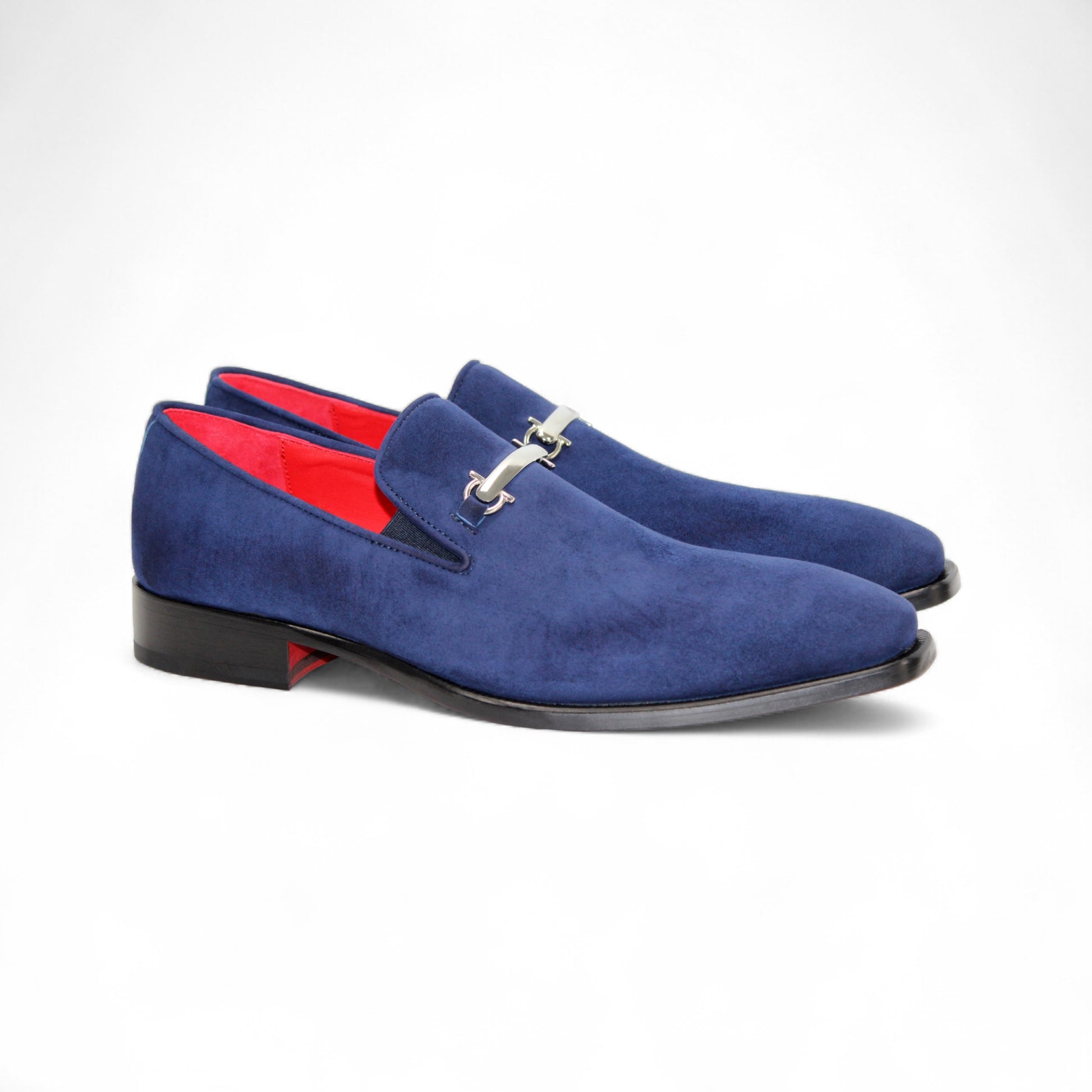 The Emilio Franco Francesco Navy is a handcrafted blue suede men’s dress shoe featuring silver metal detail, a red inner lining, and black sole, displayed in side profile against a white background.