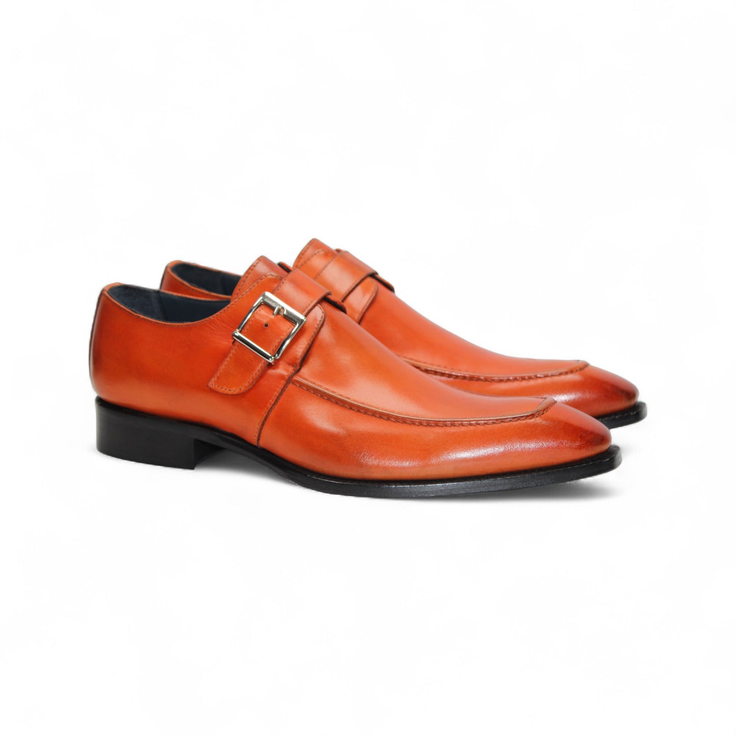 The Duca Di Matiste Duca Garda Orange dress shoe, crafted from genuine leather with a side buckle and low black heel, is shown in profile on a white background—a refined, modern wardrobe addition.