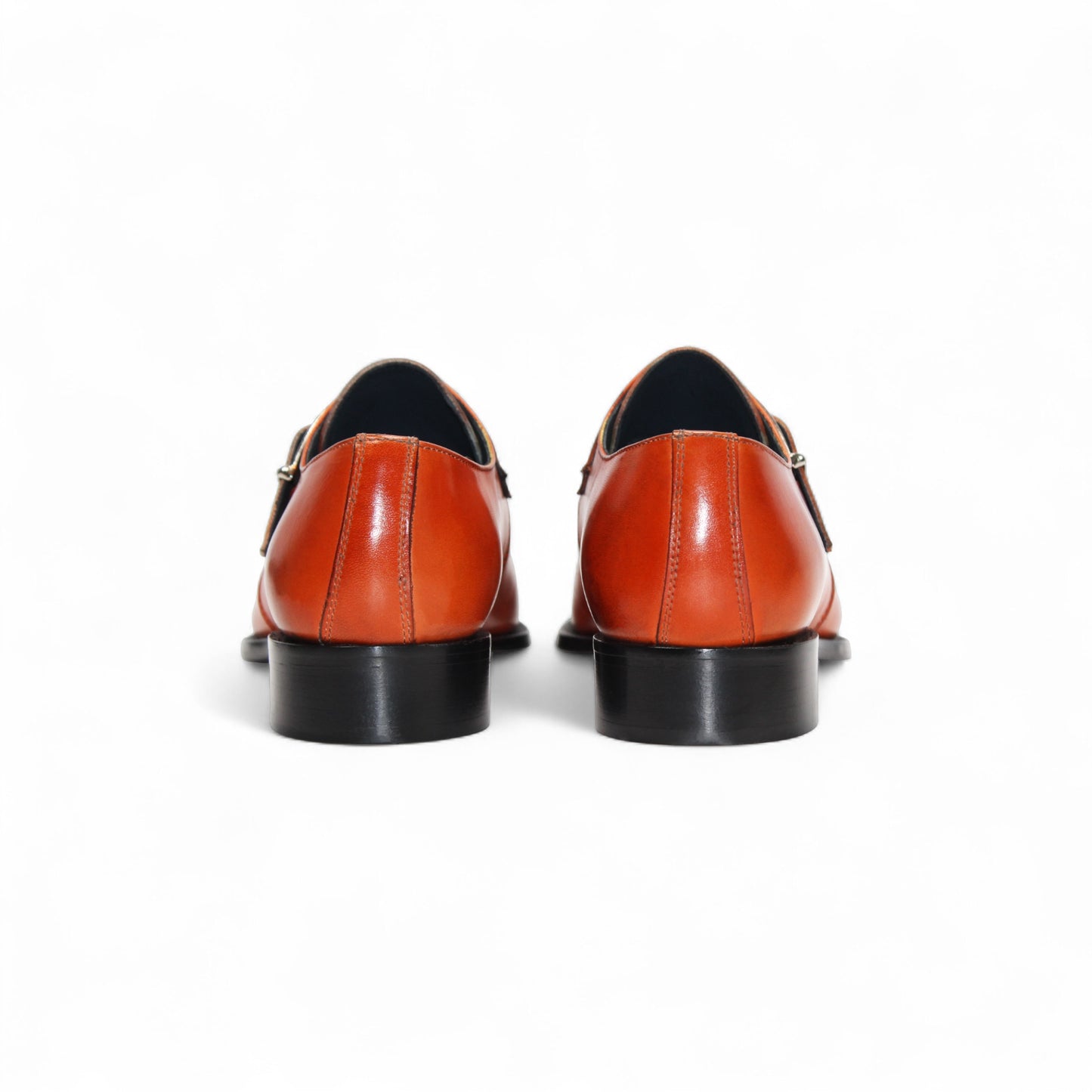 The Duca Di Matiste Duca Garda Orange dress shoe, crafted from genuine leather with a side buckle and low black heel, is shown in profile on a white background—a refined, modern wardrobe addition.