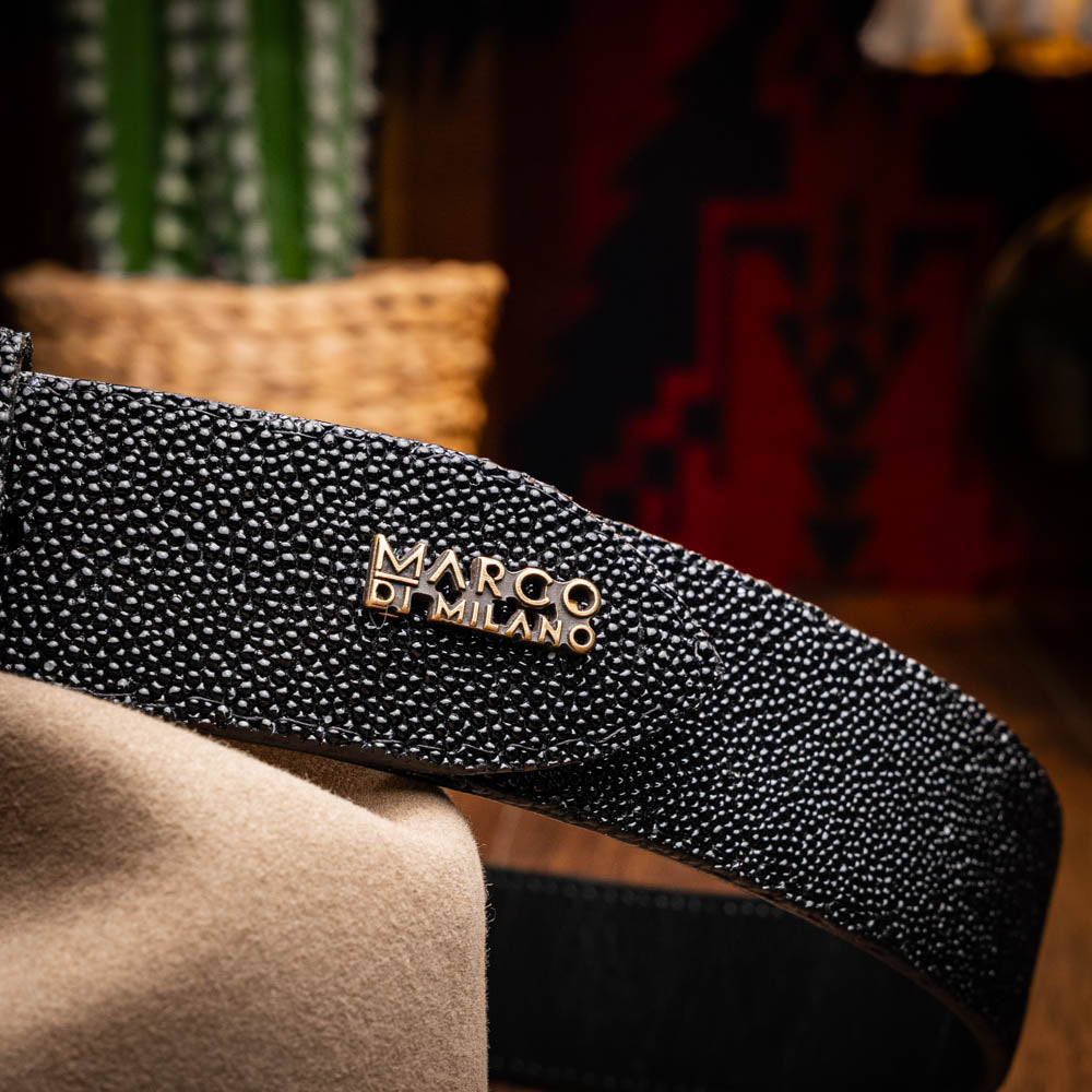 The Georgia Belt Black by Marco Di Milano is a luxury men's belt made from genuine stingray skin, featuring a bold black texture and a large gold "MD" buckle.