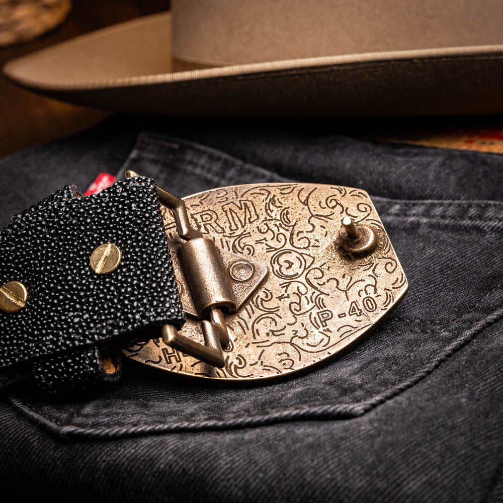 The Georgia Belt Black by Marco Di Milano is a luxury men's belt made from genuine stingray skin, featuring a bold black texture and a large gold "MD" buckle.
