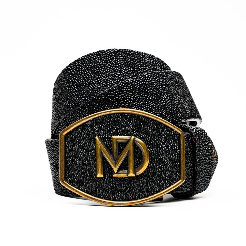 The Georgia Belt Black by Marco Di Milano is a luxury men's belt made from genuine stingray skin, featuring a bold black texture and a large gold "MD" buckle.