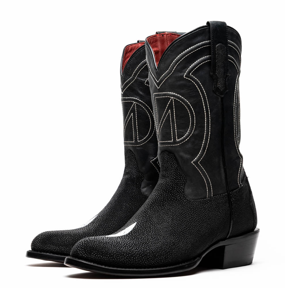 A pair of Georgia Black handcrafted western boots by Marco Di Milano, featuring white stitching—one boot upright and the other on its side displaying the branded sole.