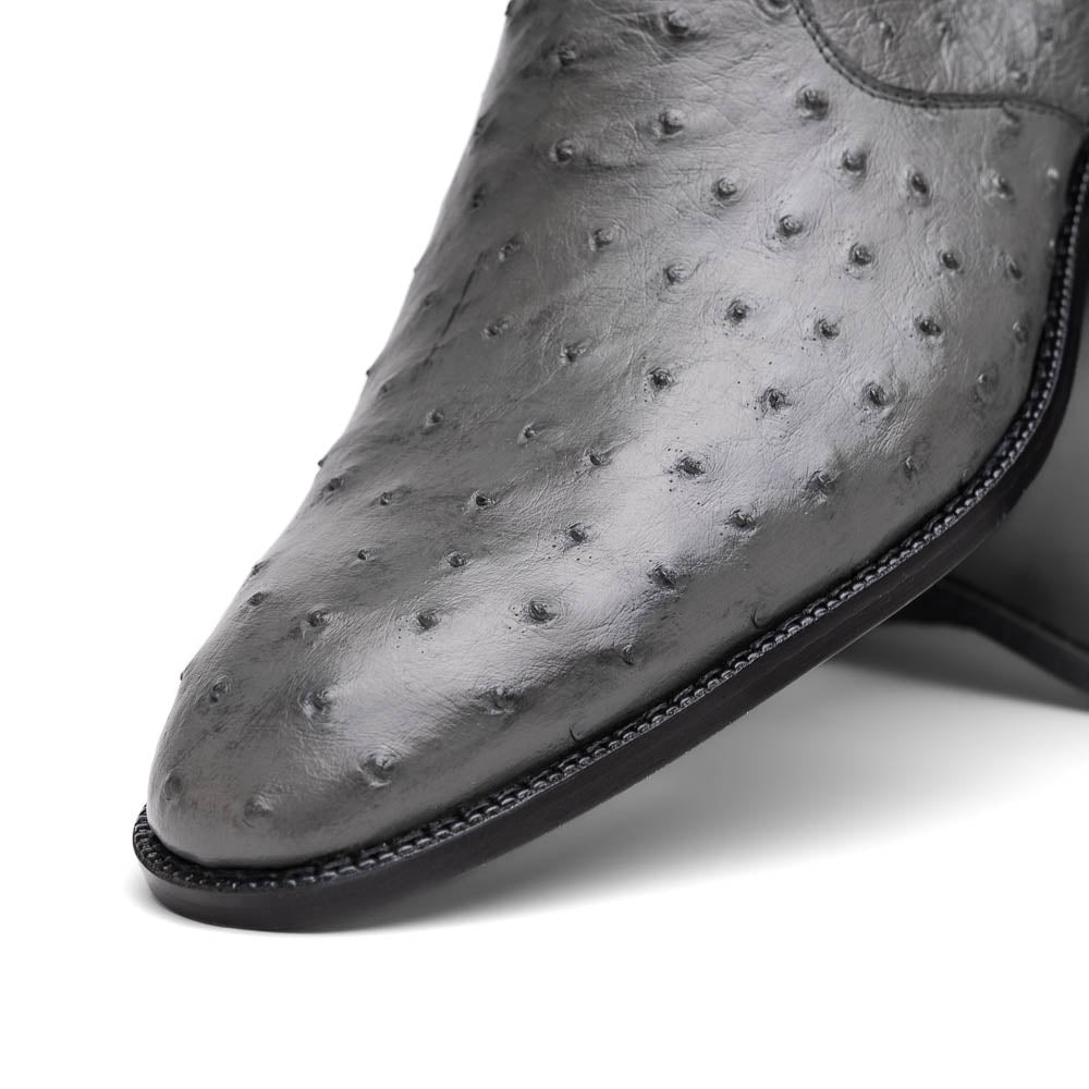 The Giorgio Serpentine Gray boots by Marco Di Milano—crafted from genuine ostrich quill leather—feature one upright and one on its side to reveal the sole, highlighting luxurious materials and exceptional craftsmanship.