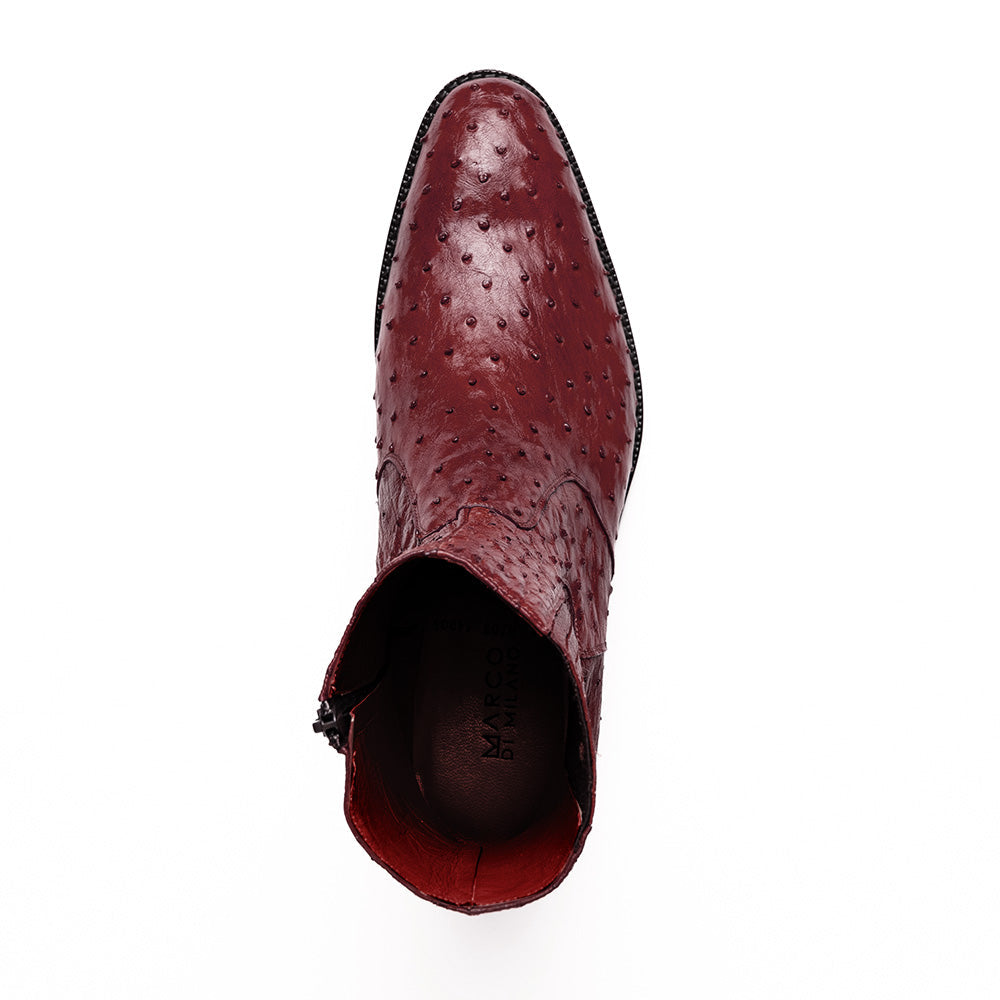 Introducing Giorgio Wine by Marco Di Milano: a pair of luxurious men's boots handcrafted in genuine burgundy ostrich leather, featuring a distinctive textured pattern, side zipper, elastic panel, and a sleek black sole—sophisticatedly presented against a white background.