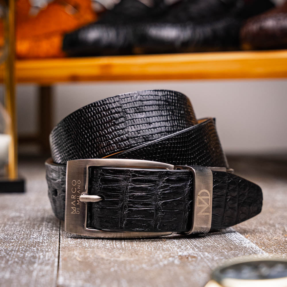 The Giovanni Belt Black by Marco Di Milano features black textured leather and a silver rectangular buckle, displayed coiled on a white background.