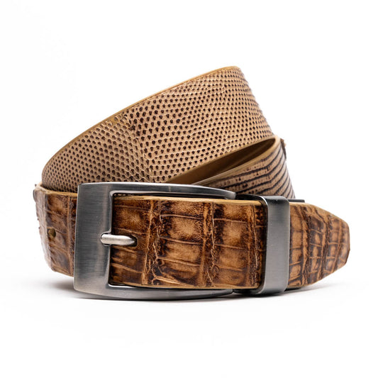 The Giovanni Belt Pantano Orix by Marco Di Milano is a brown leather belt with a silver buckle, showcasing crocodile embossing and a dotted design.