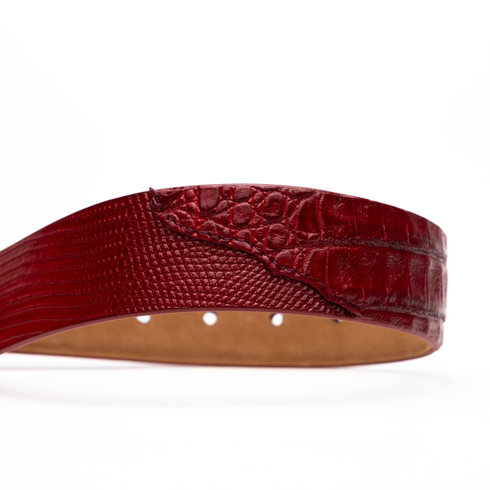 The Giovanni Belt Red by Marco Di Milano is a rolled red leather belt with a textured finish and a silver buckle, reflecting the refined style of genuine lizard ring-caiman belly belts.