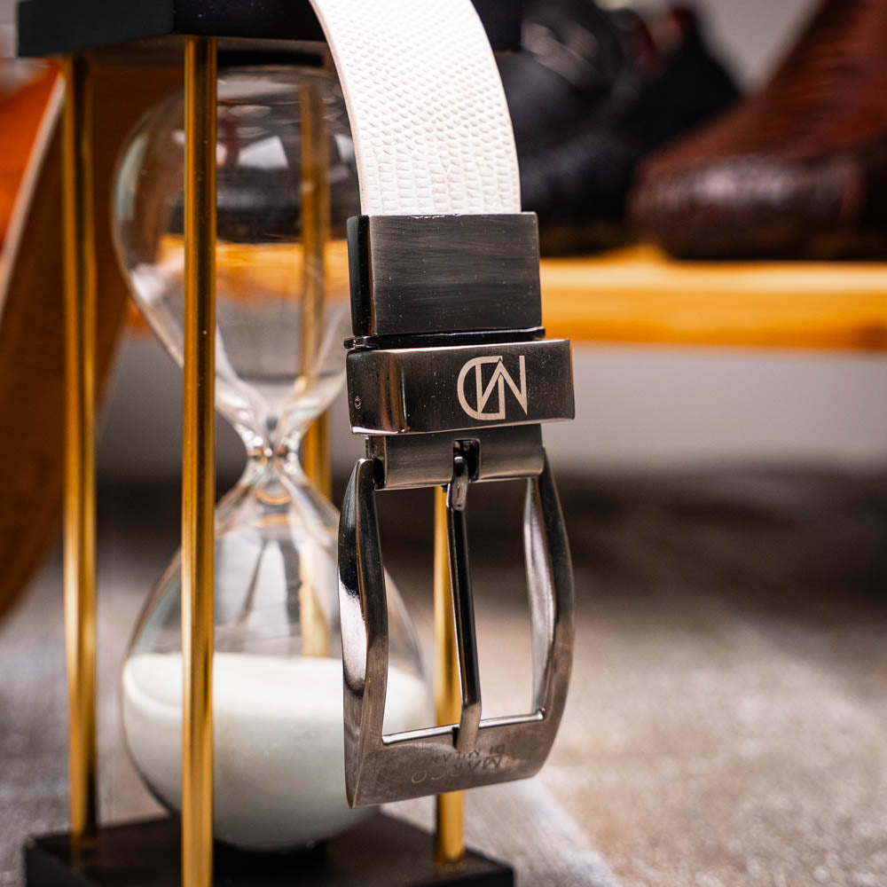 The Giovanni Belt White by Marco Di Milano is a white textured luxury men's leather belt with a silver buckle engraved with "Marco Di Milano" and the initials "MDM.