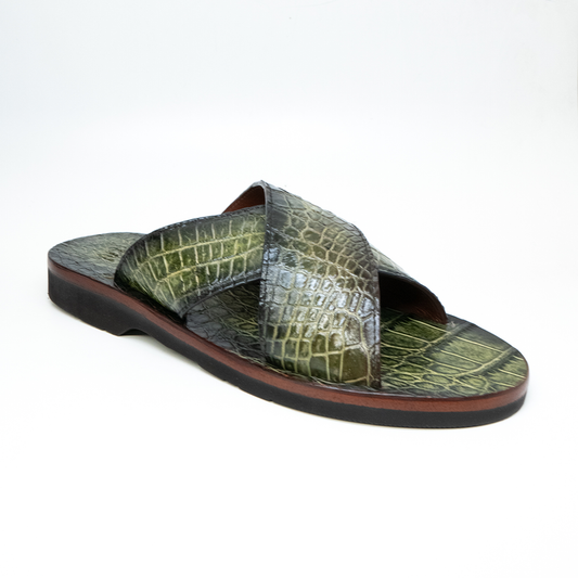 The Elios Green by Marco Di Milano is a luxurious sandal featuring green crocodile-patterned leather, crisscross straps, a flat sole, and hand-painted finishes, beautifully displayed on a white background.