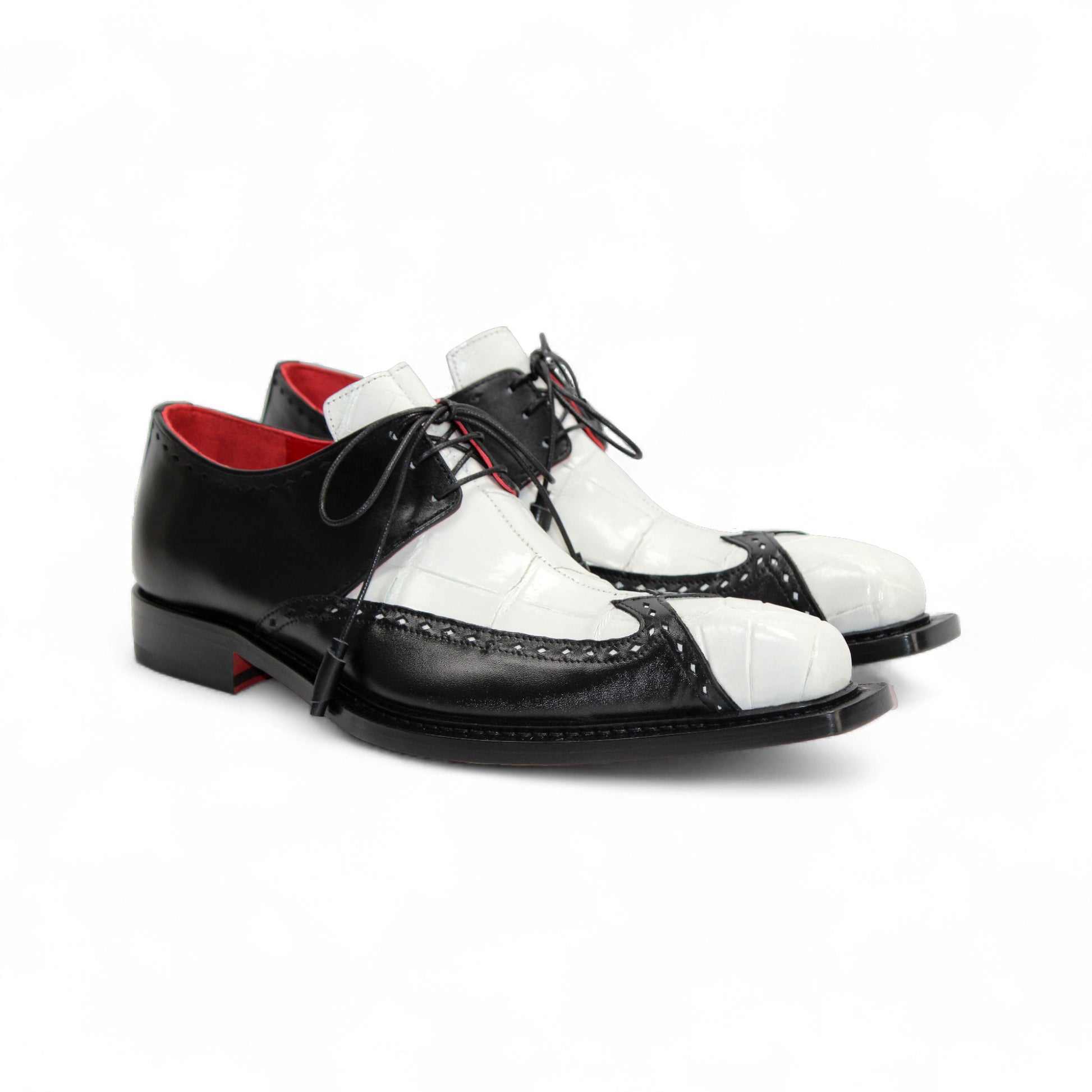 The Fennix Harry White/Black by Fennix of Italy is a leather dress shoe with black and white panels, laces, a leather sole, low heel, and red inner lining, highlighting Italian craftsmanship in profile on a white background.