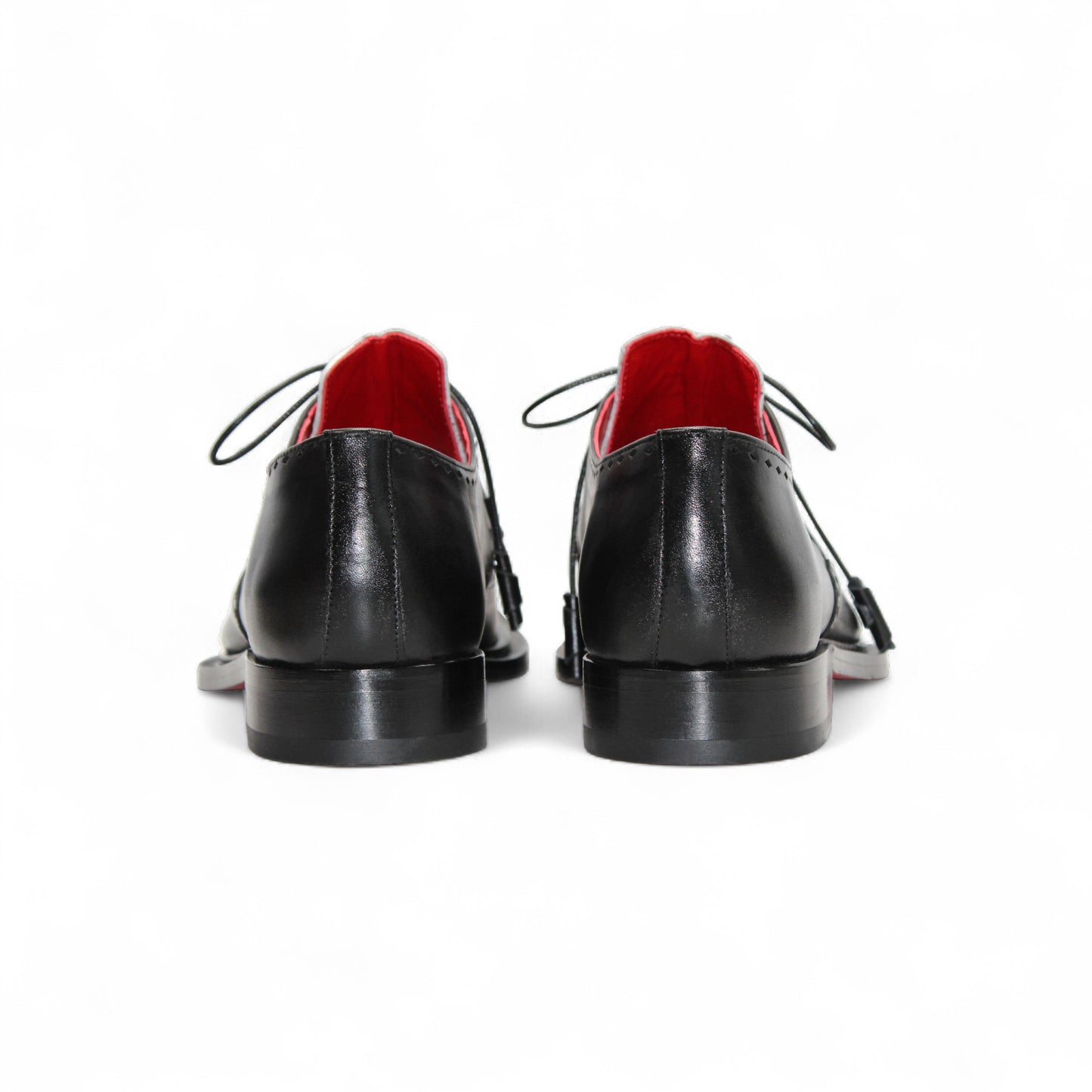 The Fennix Harry White/Black by Fennix of Italy is a leather dress shoe with black and white panels, laces, a leather sole, low heel, and red inner lining, highlighting Italian craftsmanship in profile on a white background.