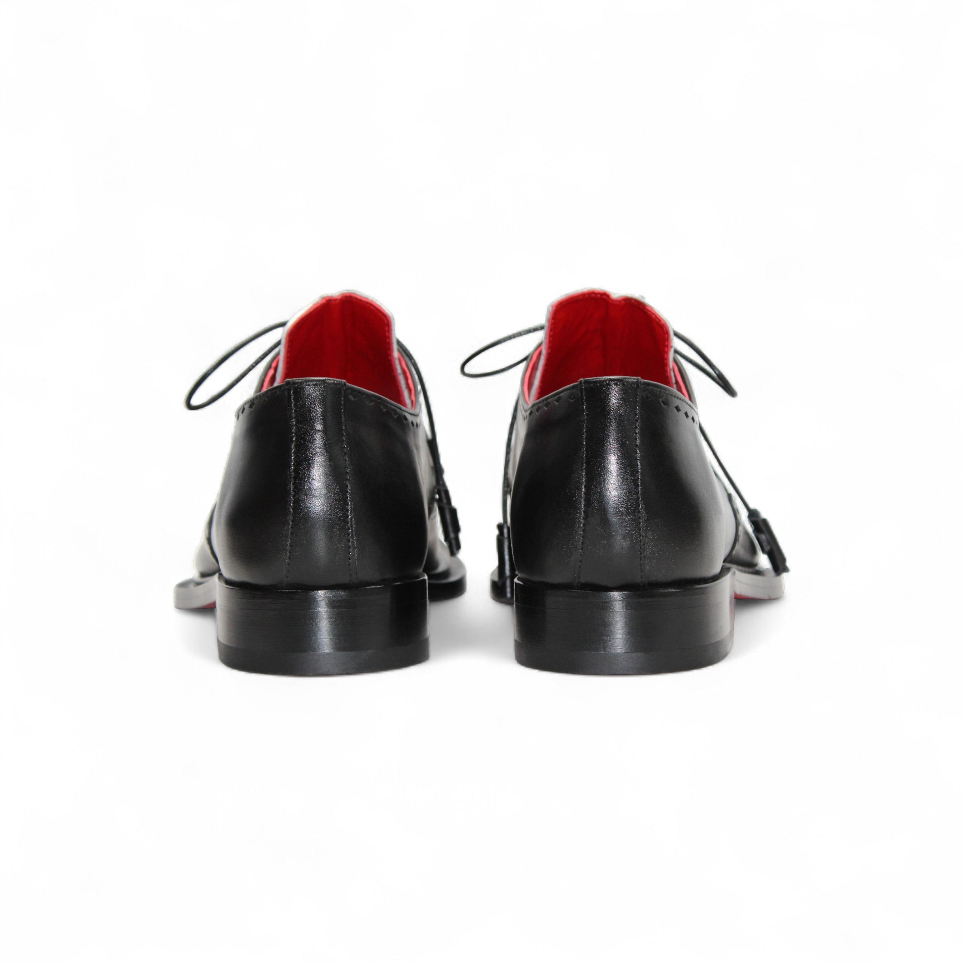 The Fennix Harry White/Black by Fennix of Italy is a leather dress shoe with black and white panels, laces, a leather sole, low heel, and red inner lining, highlighting Italian craftsmanship in profile on a white background.