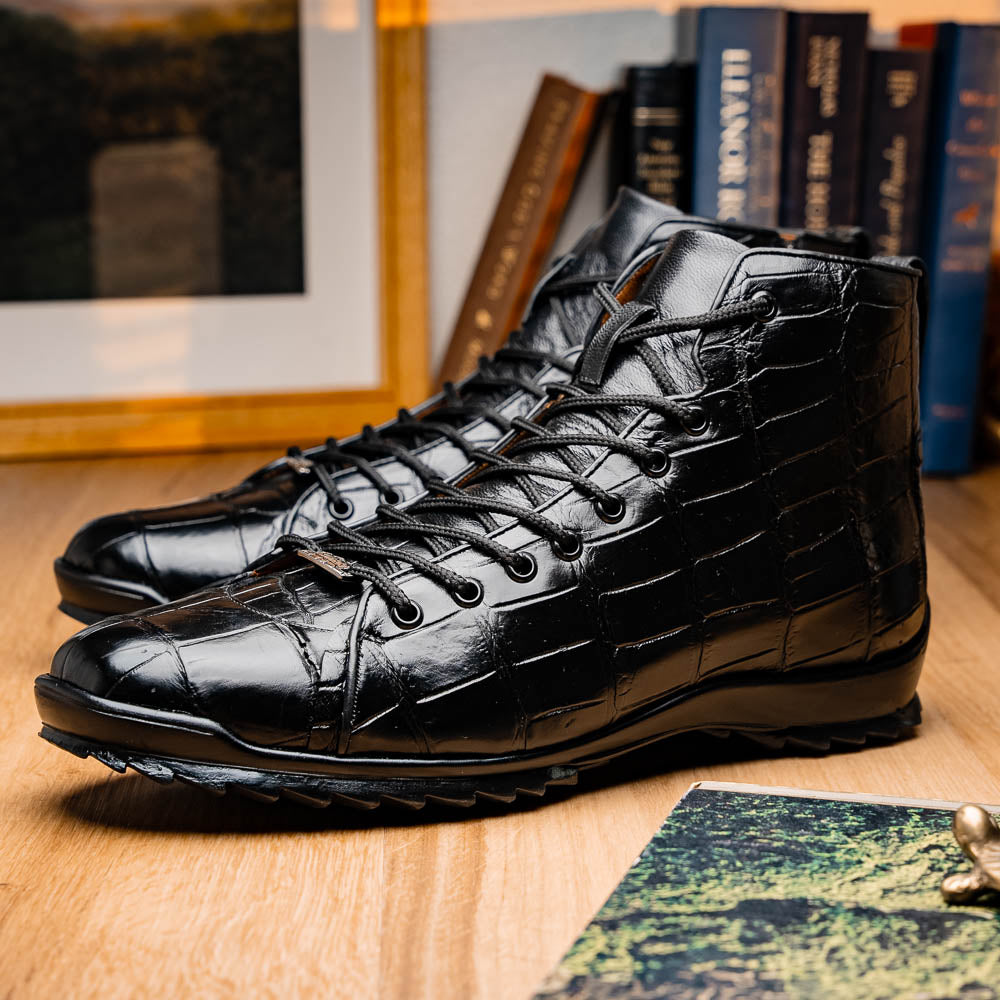 The Hermond Black boots by Marco Di Milano feature high-top, crocodile-patterned black leather and durable rubber soles—one boot stands upright while the other is propped beneath it.