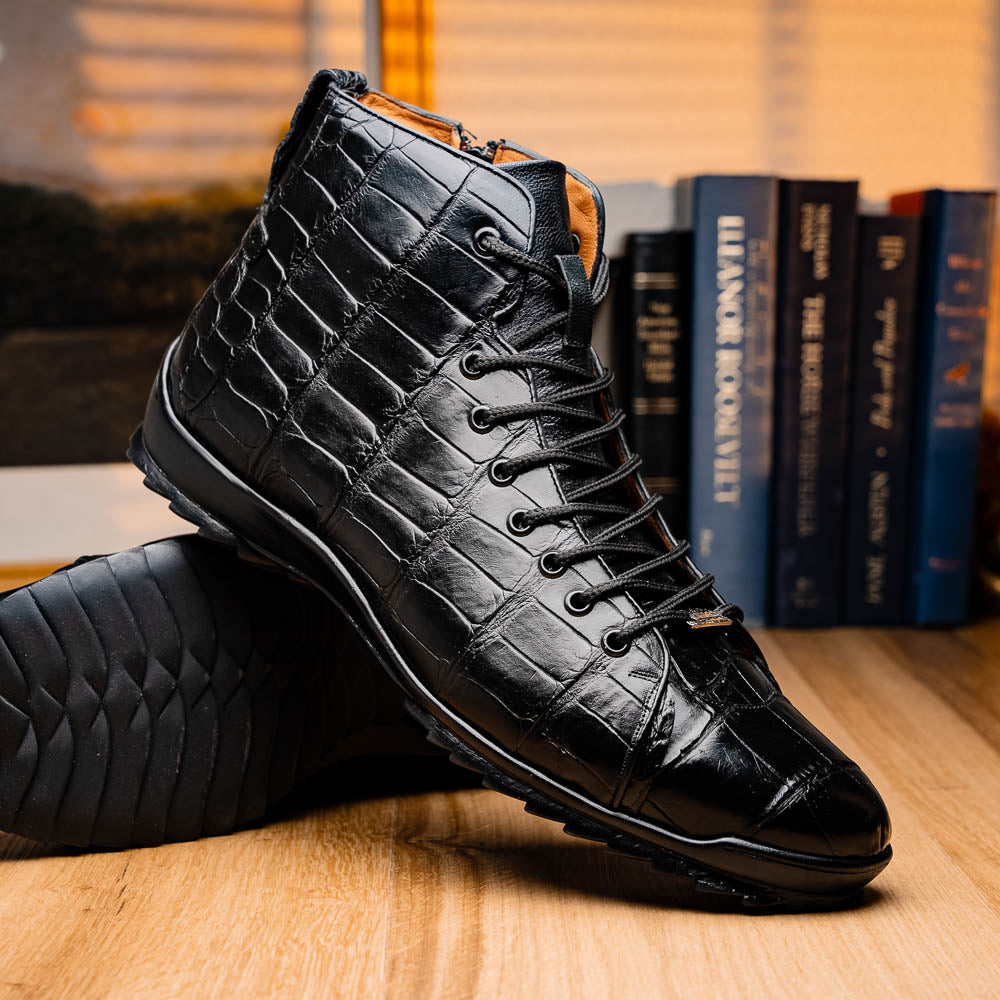 The Hermond Black boots by Marco Di Milano feature high-top, crocodile-patterned black leather and durable rubber soles—one boot stands upright while the other is propped beneath it.