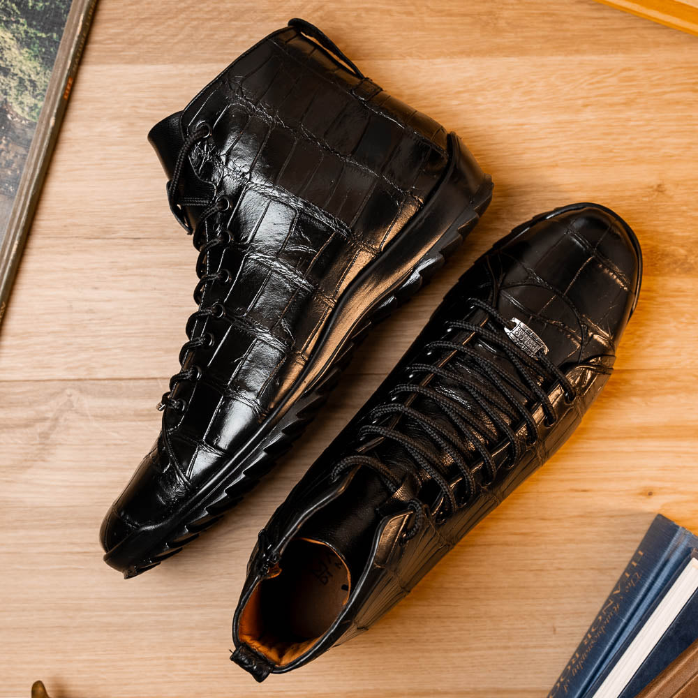 The Hermond Black boots by Marco Di Milano feature high-top, crocodile-patterned black leather and durable rubber soles—one boot stands upright while the other is propped beneath it.