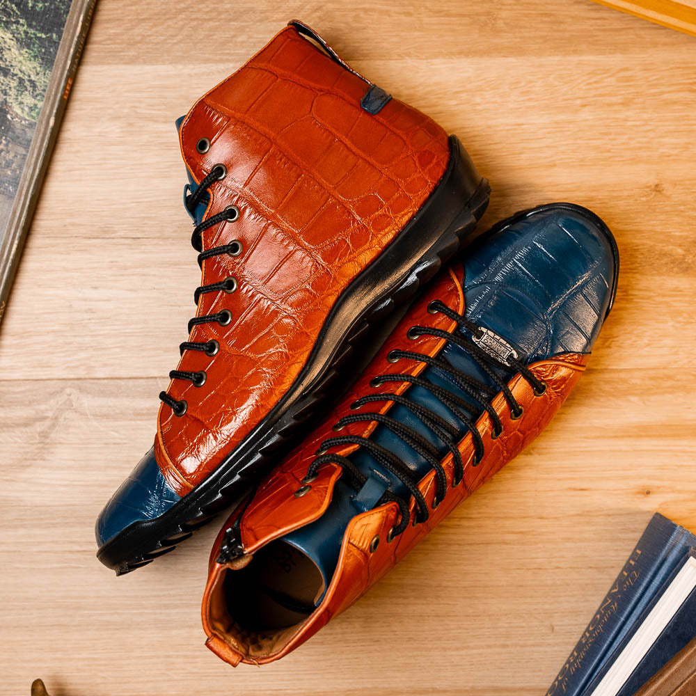 The Hermond Blue Jeans/Honey by Marco Di Milano is a luxury high-top with textured leather in orange and blue, black laces, metal eyelets, and a black rubber sole with unique hand-painted details.