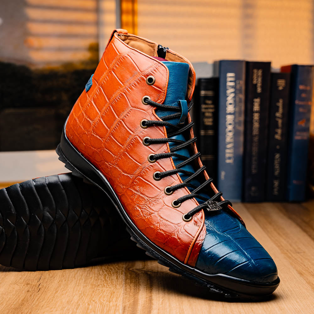 The Hermond Blue Jeans/Honey by Marco Di Milano is a luxury high-top with textured leather in orange and blue, black laces, metal eyelets, and a black rubber sole with unique hand-painted details.