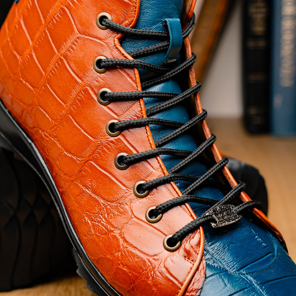 The Hermond Blue Jeans/Honey by Marco Di Milano is a luxury high-top with textured leather in orange and blue, black laces, metal eyelets, and a black rubber sole with unique hand-painted details.