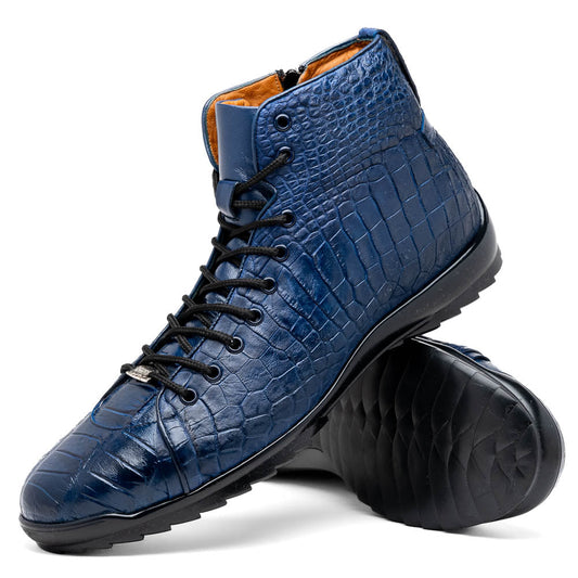 The Hermond Navy by Marco Di Milano: luxury high-top shoes in blue crocodile-patterned leather with genuine exotics, black laces, and black rubber soles—one shoe stands upright, the other lies on its side.