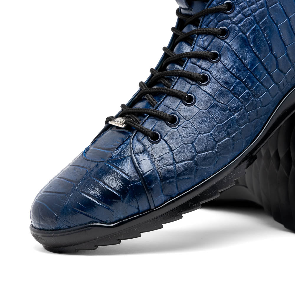 The Hermond Navy by Marco Di Milano: luxury high-top shoes in blue crocodile-patterned leather with genuine exotics, black laces, and black rubber soles—one shoe stands upright, the other lies on its side.