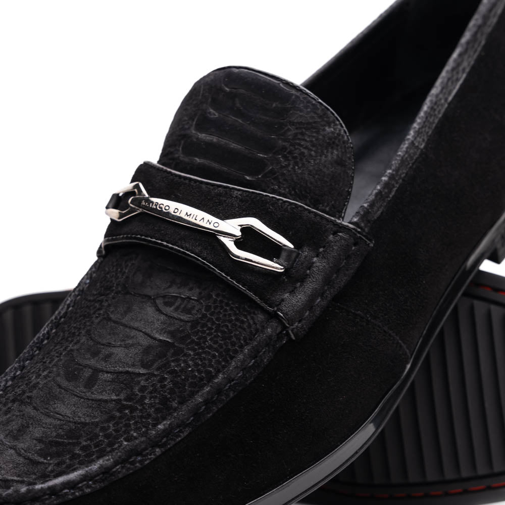 A pair of Marco Di Milano Hugo Black sueded ostrich leg loafers with metal chain detailing and textured rubber soles, one upright and one on its side, display refined luxury craftsmanship.