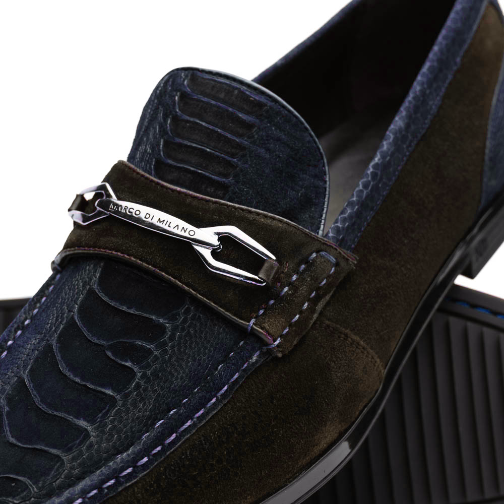A pair of Marco Di Milano Hugo Navy / Brown loafers with textured uppers, metal bit detailing, and black rubber soles—shown stylishly with one shoe leaning on the other—a true statement in luxury footwear.