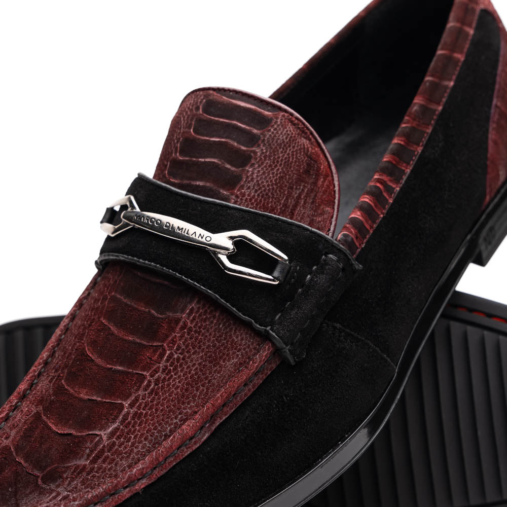 The Marco Di Milano Hugo Wine / Black men's loafers feature burgundy textured leather, black suede panels, metal buckles, and black rubber soles with red accents—luxury footwear for refined style.