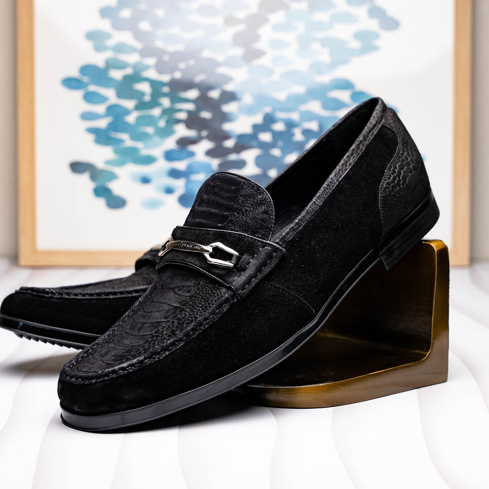 A pair of Marco Di Milano Hugo Black sueded ostrich leg loafers with metal chain detailing and textured rubber soles, one upright and one on its side, display refined luxury craftsmanship.