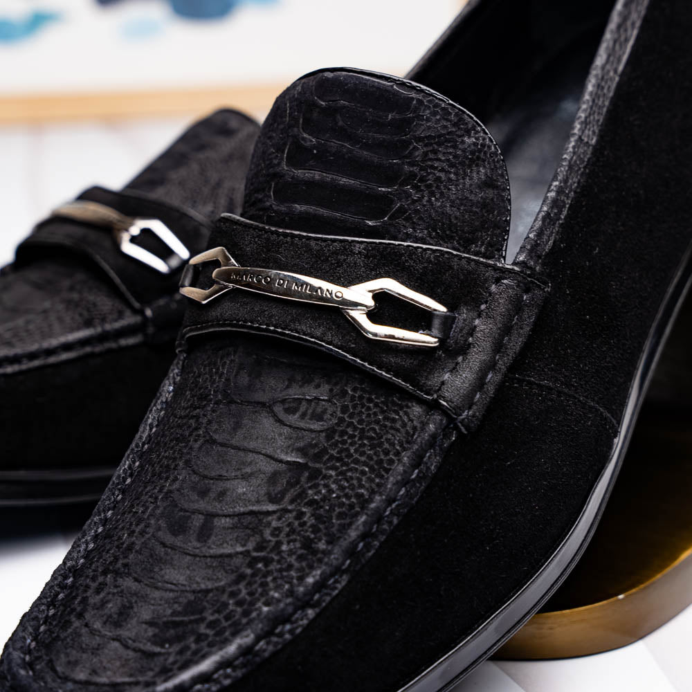 A pair of Marco Di Milano Hugo Black sueded ostrich leg loafers with metal chain detailing and textured rubber soles, one upright and one on its side, display refined luxury craftsmanship.