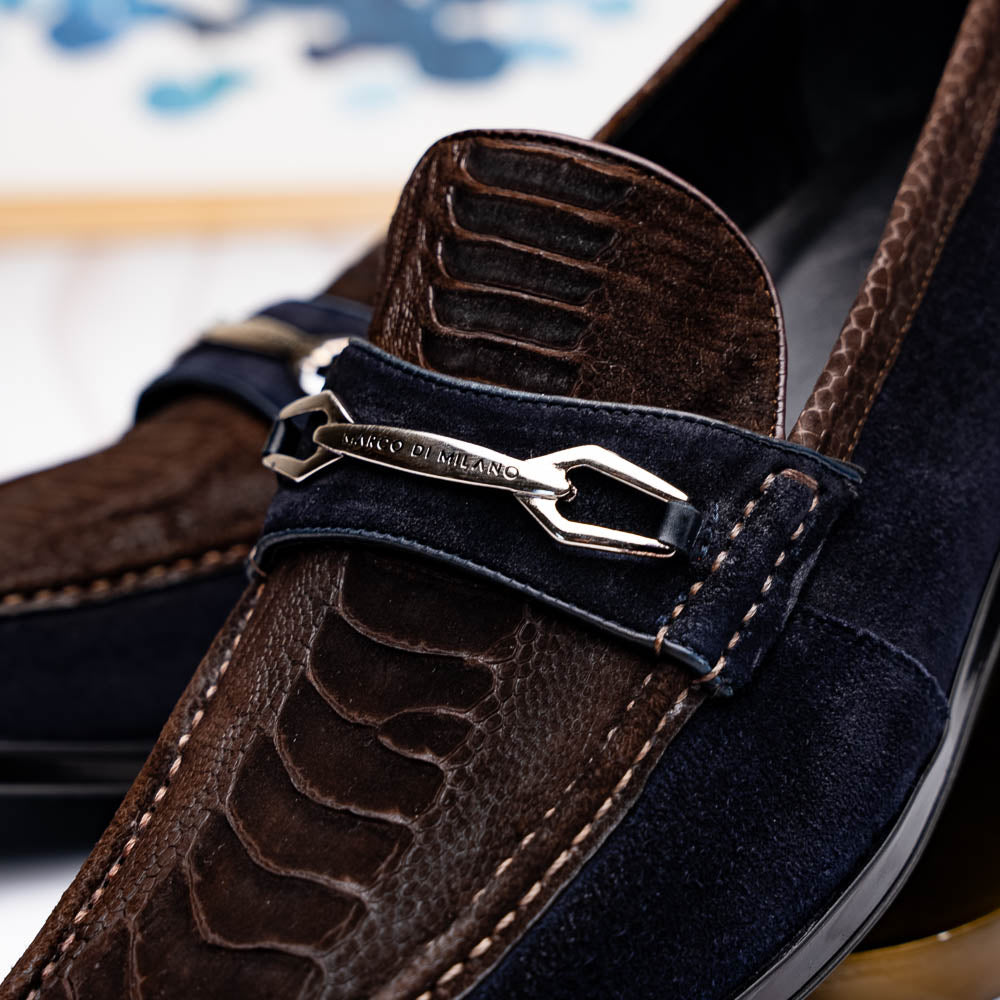 The Marco Di Milano Hugo Brown / Navy men's loafers feature dark brown textured leather, navy suede trim, a metal buckle detail, and black rubber soles for a luxurious look.