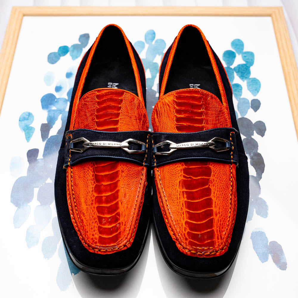 The Hugo Orange / Navy by Marco Di Milano is a men's loafer in orange crocodile-textured leather with navy suede accents, silver bit detail, and a black rubber sole with red stitching—ideal for luxury footwear fans.