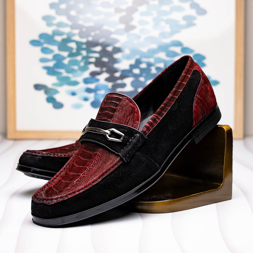 The Marco Di Milano Hugo Wine / Black men's loafers feature burgundy textured leather, black suede panels, metal buckles, and black rubber soles with red accents—luxury footwear for refined style.
