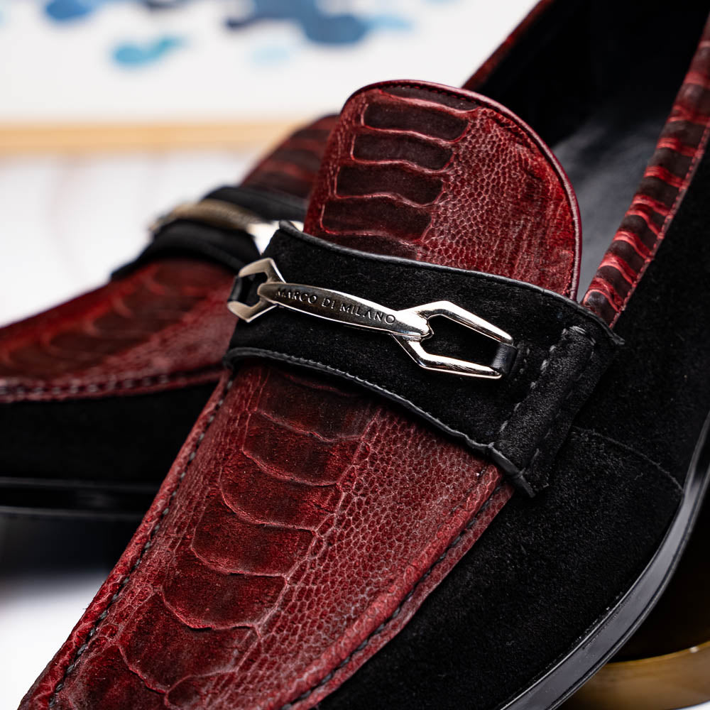 The Marco Di Milano Hugo Wine / Black men's loafers feature burgundy textured leather, black suede panels, metal buckles, and black rubber soles with red accents—luxury footwear for refined style.