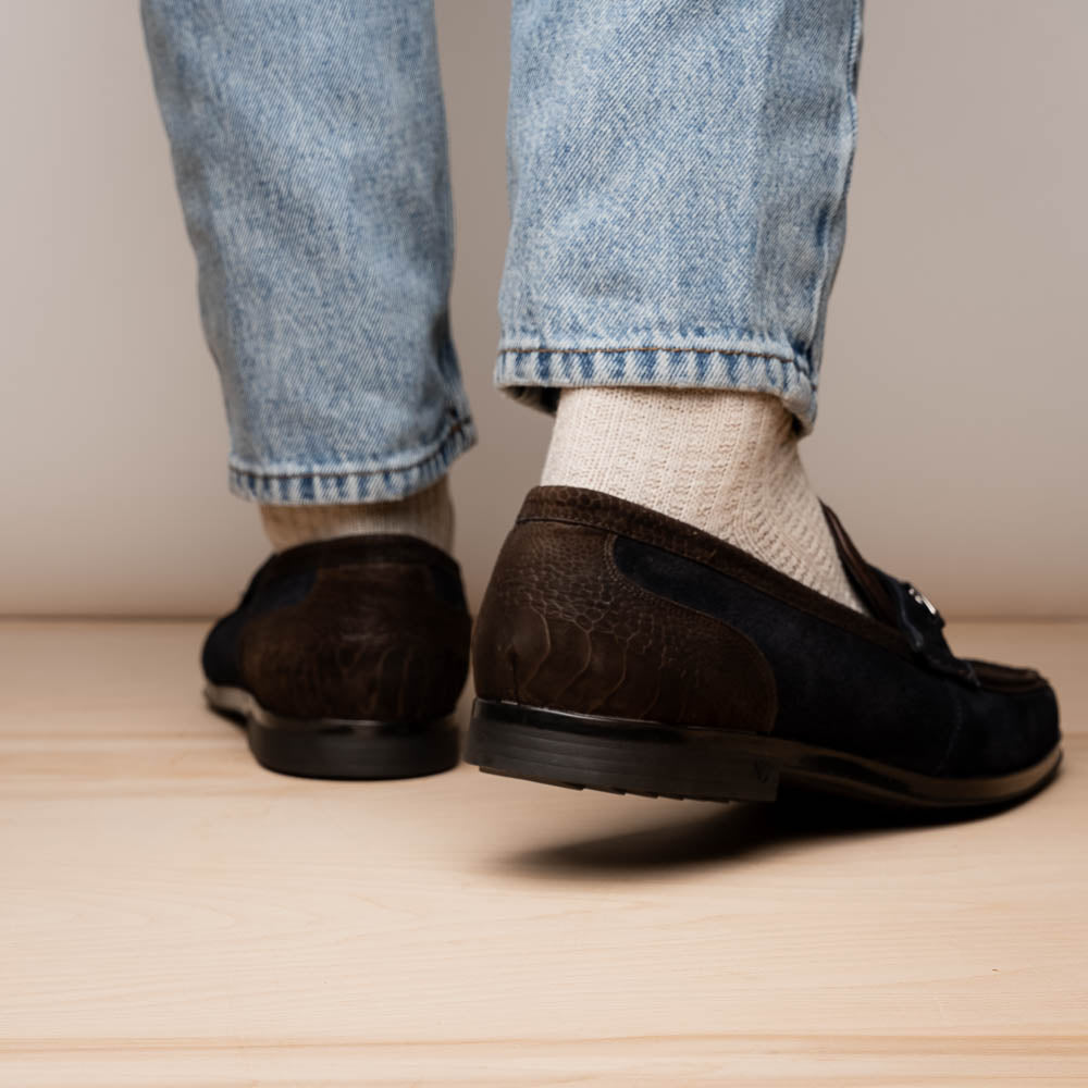 The Marco Di Milano Hugo Brown / Navy men's loafers feature dark brown textured leather, navy suede trim, a metal buckle detail, and black rubber soles for a luxurious look.