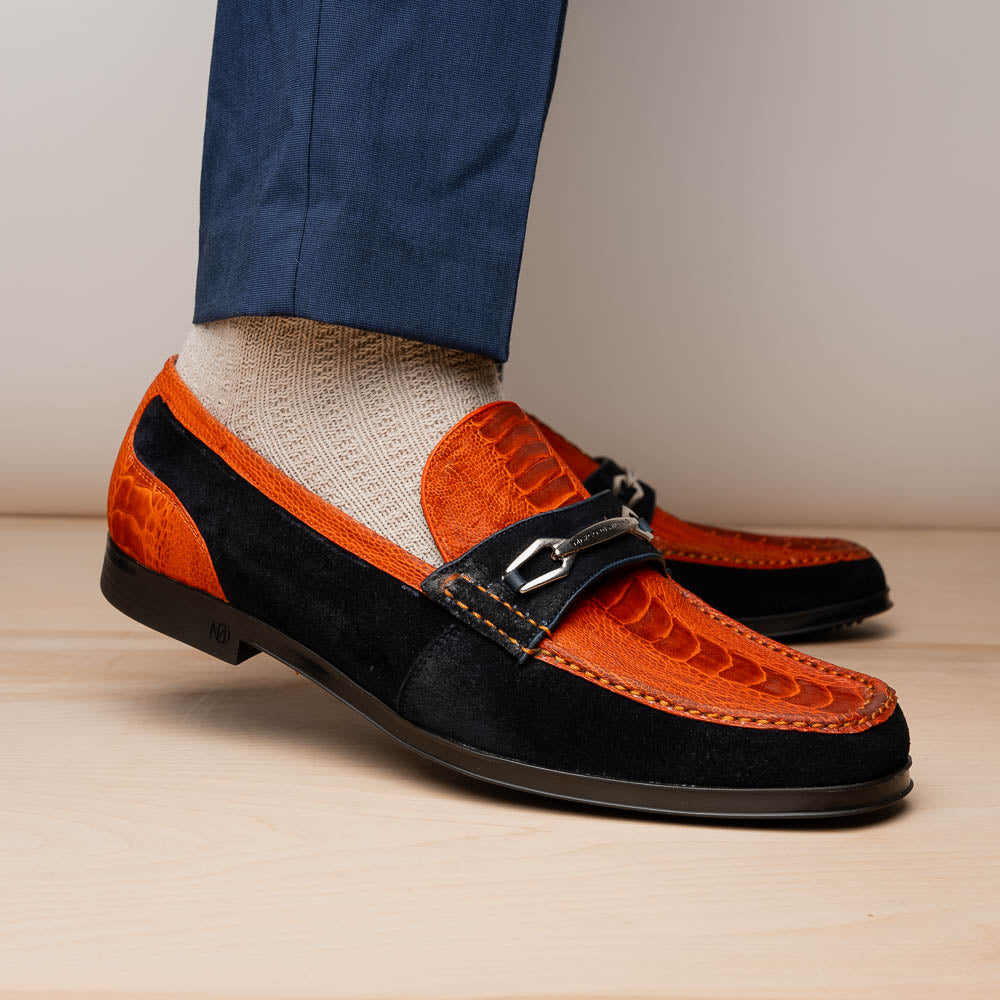 The Hugo Orange / Navy by Marco Di Milano is a men's loafer in orange crocodile-textured leather with navy suede accents, silver bit detail, and a black rubber sole with red stitching—ideal for luxury footwear fans.