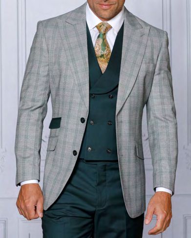 A man in the INSOMNIA PARIS-1 3PC Tailored fit Sage Suit by Insomnia, featuring a checkered suit jacket and double-breasted waistcoat, complemented by a patterned tie, stands against a light background, epitomizing the elegance of this ensemble.