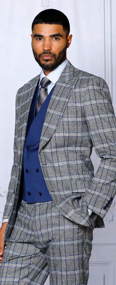 A man, dressed in an INSOMNIA PARIS-2 3PC tailored fit sapphire suit by Insomnia, featuring a blue vest and tie, stands against a neutral background.