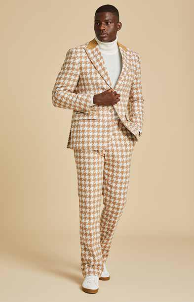 A man models the Inserch Houndstooth Suit BL264-09 Khaki by Inserch, paired with a white turtleneck, standing against a beige background and highlighting the suit's modern fit.