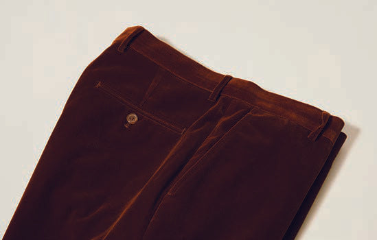 Close-up of Inserch's Aztec Velvet Pants (P502-27) in a modern fit, showcasing a visible buttoned back pocket and belt loops, laid on a neutral background.