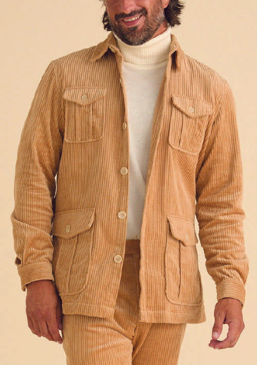 A person wearing the Inserch 4-Pocket Cord Suit BL267-09 Khaki with an adjustable back tab over a white turtleneck sweater.